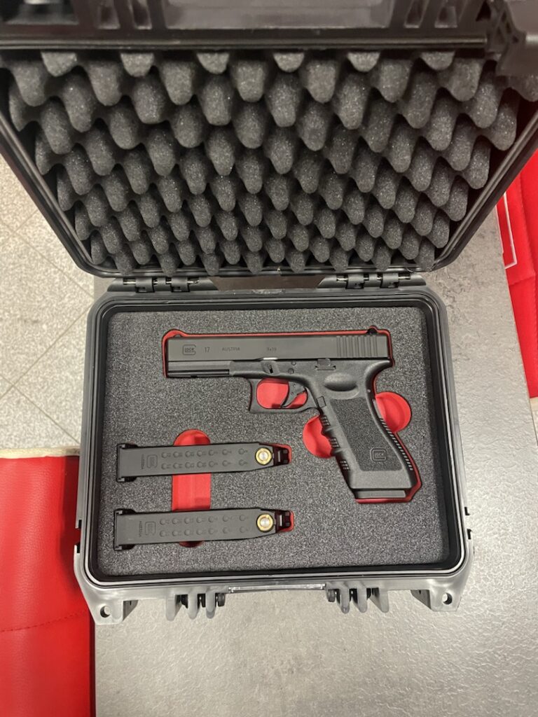 Handgun in a hard case with foam insert and two magazines